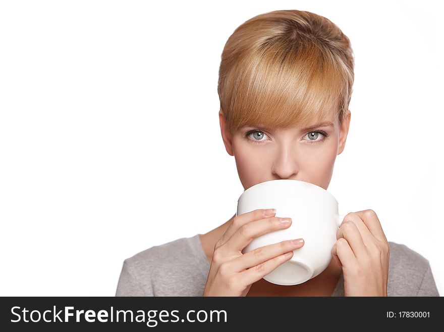 Portrait of a beautiful woman, drinking tea or coffee, isolated on white