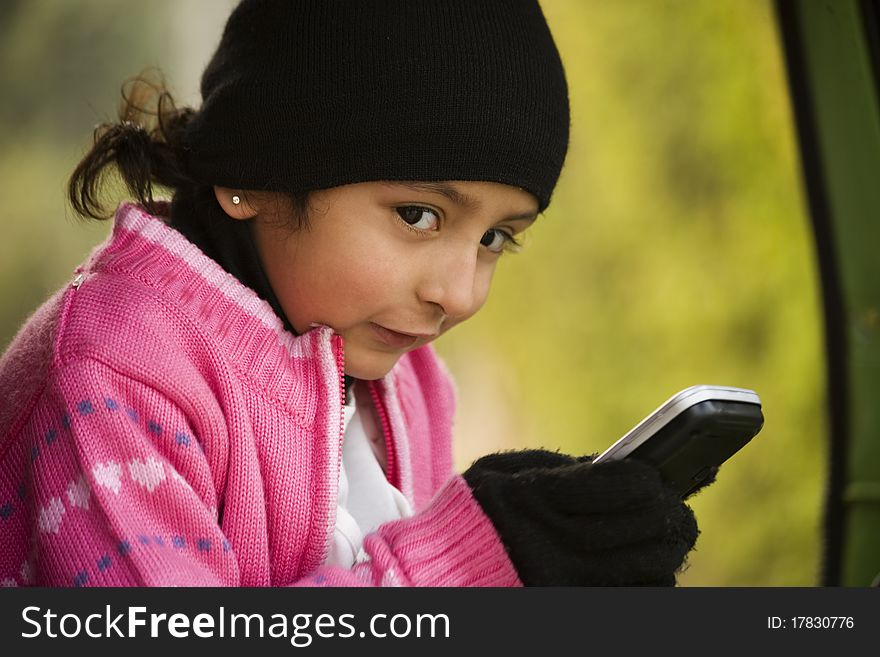 Little Girl Messaging On The Cell Phone.