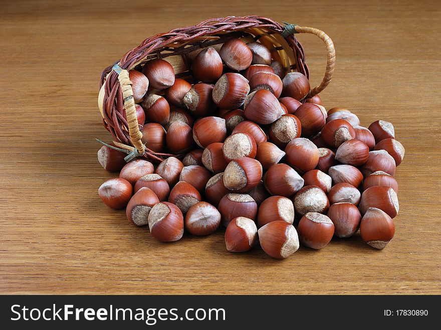 Small group of dry wood nuts on a wooden table. Small group of dry wood nuts on a wooden table