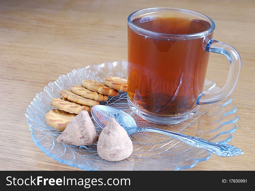 Cup of tea with sweets on a table. Cup of tea with sweets on a table