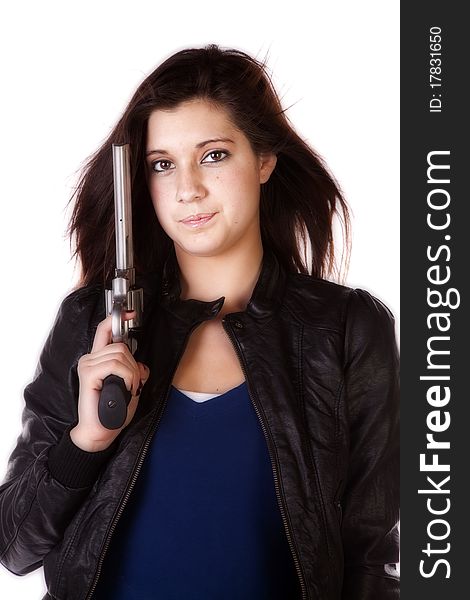 A close up of a woman holding a handgun with a serious expression on her face. A close up of a woman holding a handgun with a serious expression on her face.