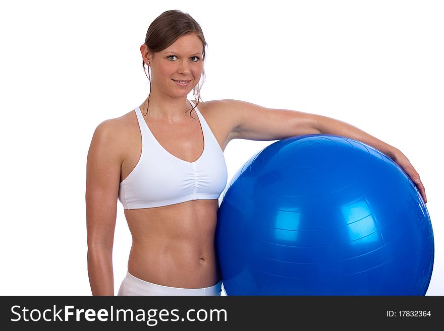 Fit and muscular young caucasian woman posing with blue exercise ball. Fit and muscular young caucasian woman posing with blue exercise ball