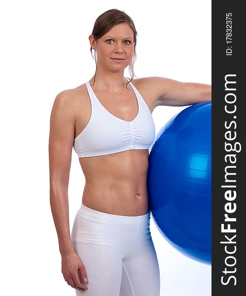 Fit and muscular young caucasian woman posing with blue exercise ball. Fit and muscular young caucasian woman posing with blue exercise ball