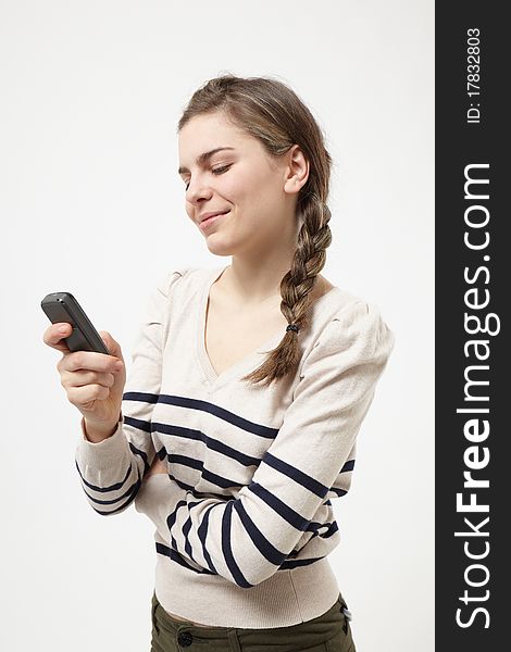 Young woman text messaging on light grey background. Young woman text messaging on light grey background