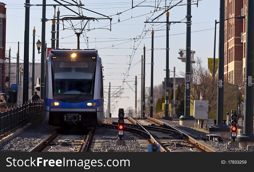 A light rail train system in a city environment. A light rail train system in a city environment