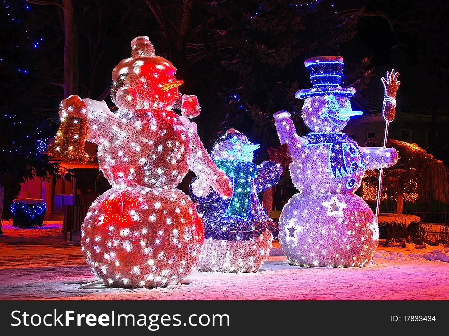 Three snowmen with holiday lights