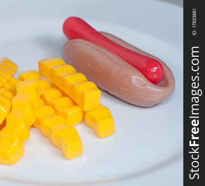 Plastic Toy Hot Dog and French Fries on a Plate. Plastic Toy Hot Dog and French Fries on a Plate