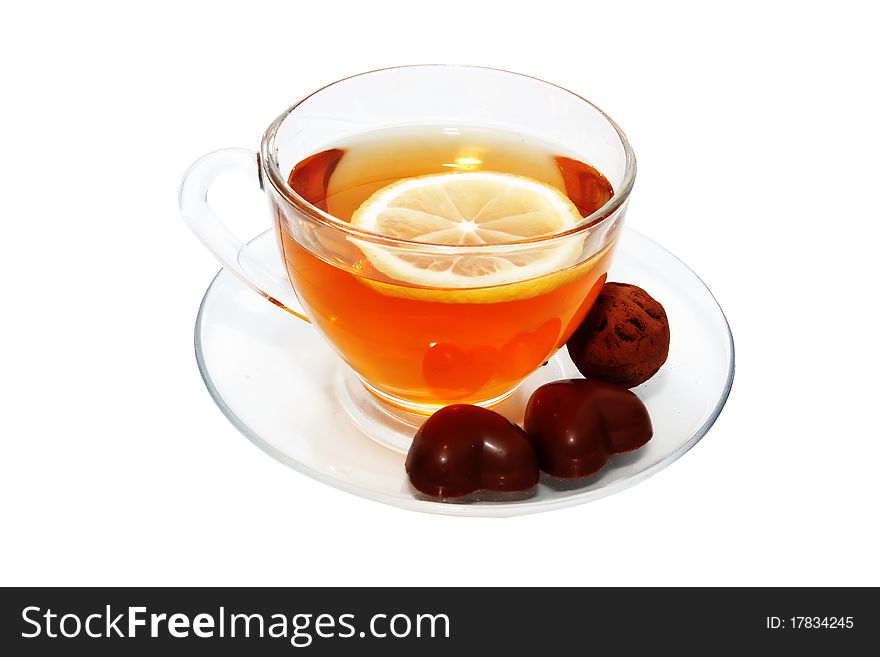 Cup of tea with lemon and chocolates