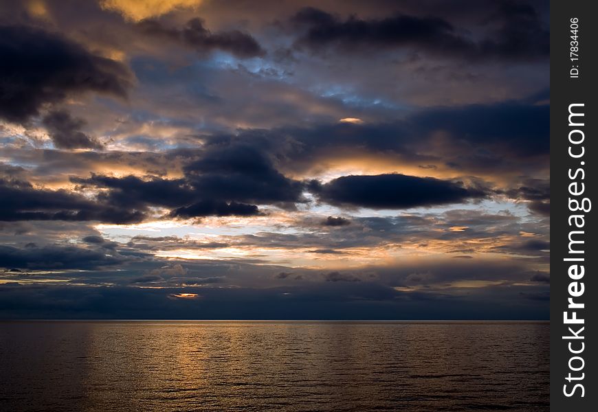 Sunrise over sea with dark sky. Sunrise over sea with dark sky.