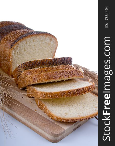 Fresh bread with ears of wheat  on a white background