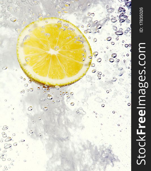 Lemon dropped into water