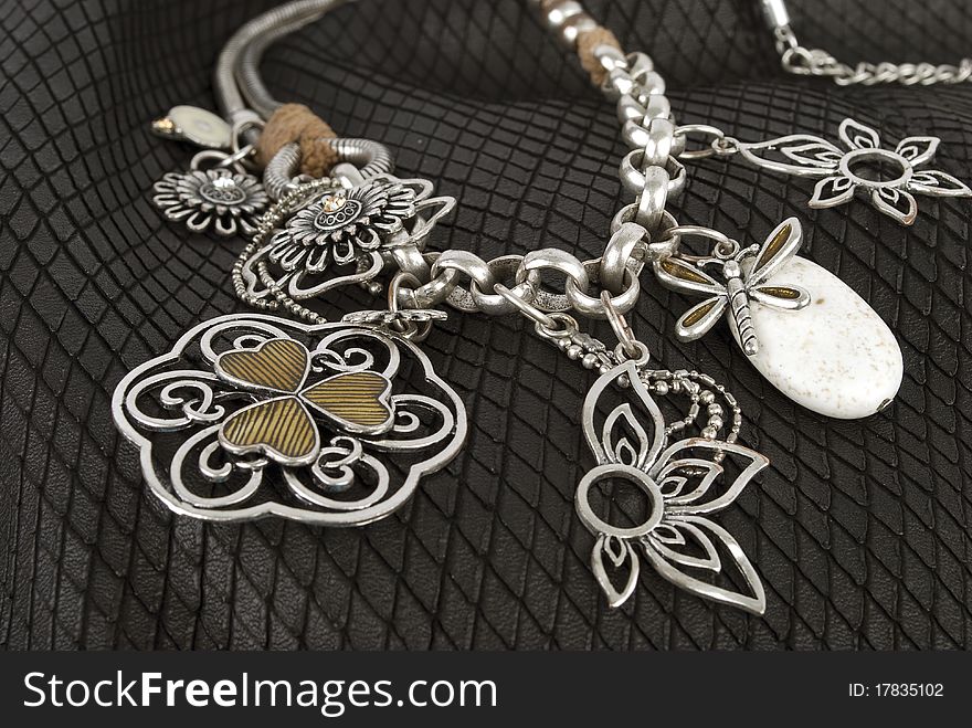 Silver necklace with flowers on the black background. Silver necklace with flowers on the black background.