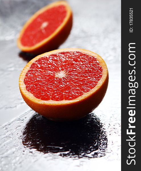 Fresh and wet grapefruit with reflection. Fresh and wet grapefruit with reflection