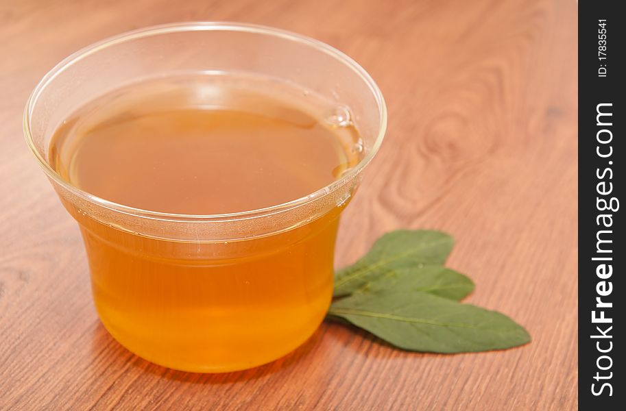 Cup of green tea on wooden table