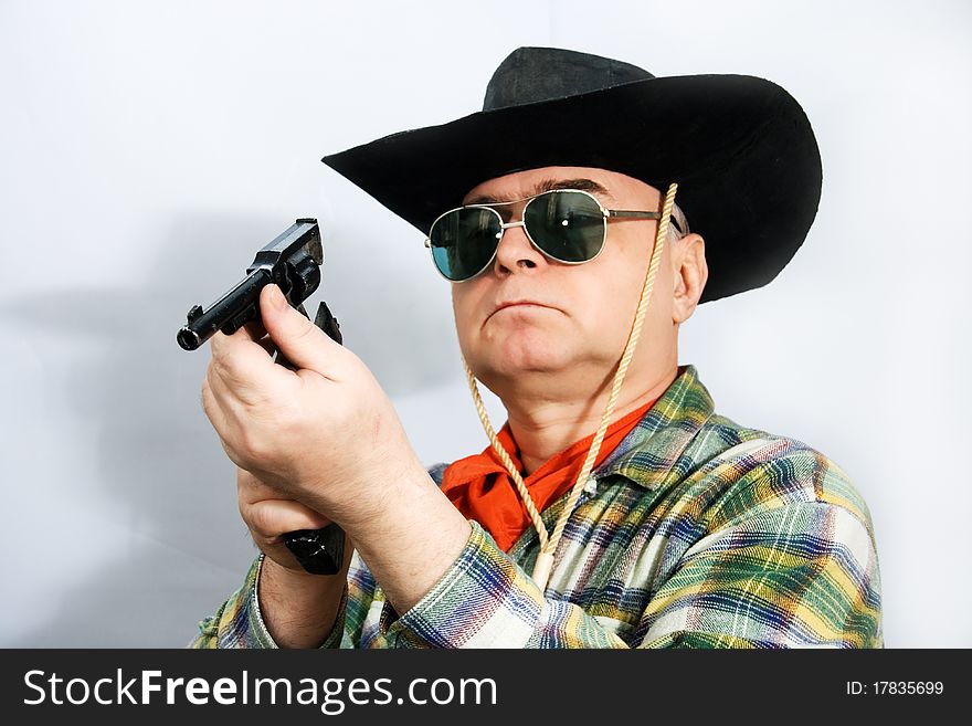 One man in cowboy dress and hat. Shooting in the studio. One man in cowboy dress and hat. Shooting in the studio.