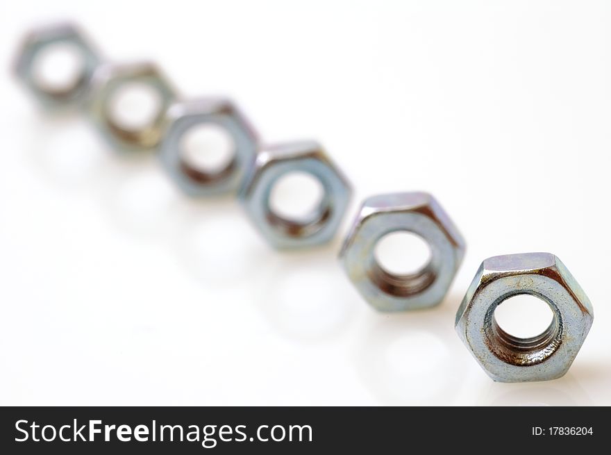 Steel nuts on a white background