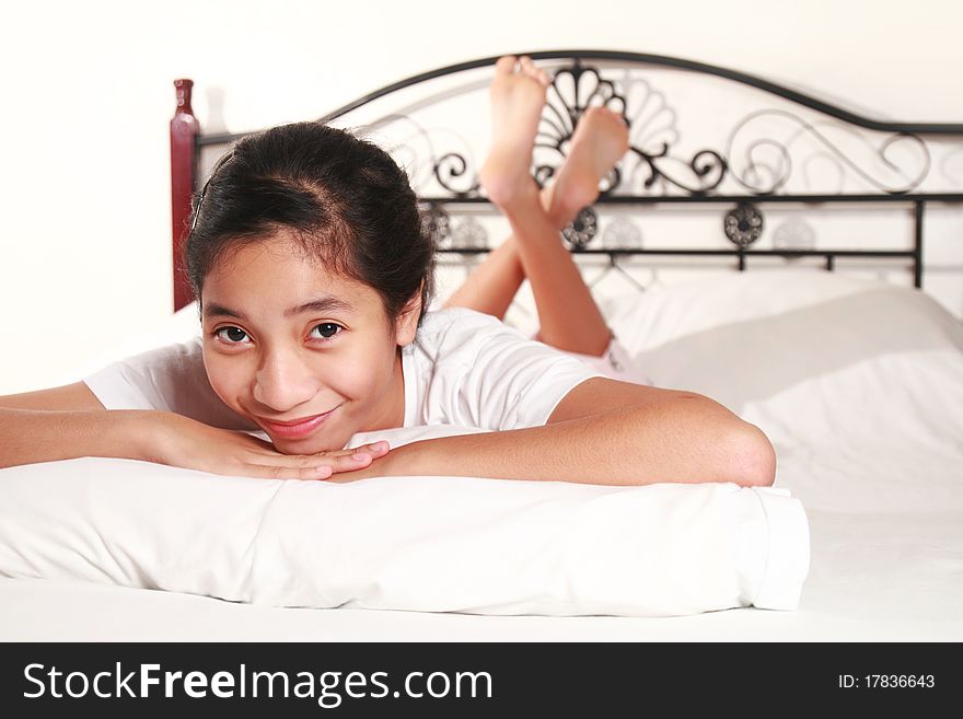 Picture of a smiling happy girl on bed