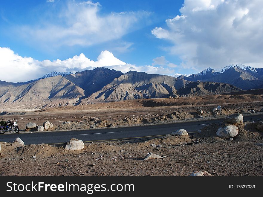 A beautiful Himalayan landscape with a lone bike standing in the corner. A beautiful Himalayan landscape with a lone bike standing in the corner.