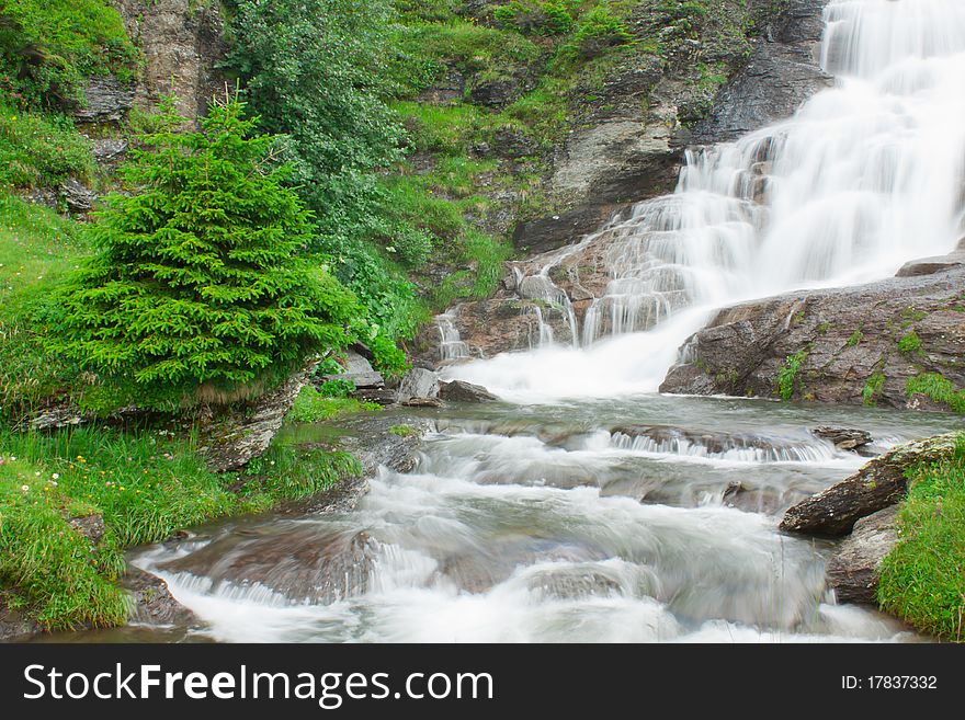 Waterfall in green alps mountains, near Grindelwald. Waterfall in green alps mountains, near Grindelwald