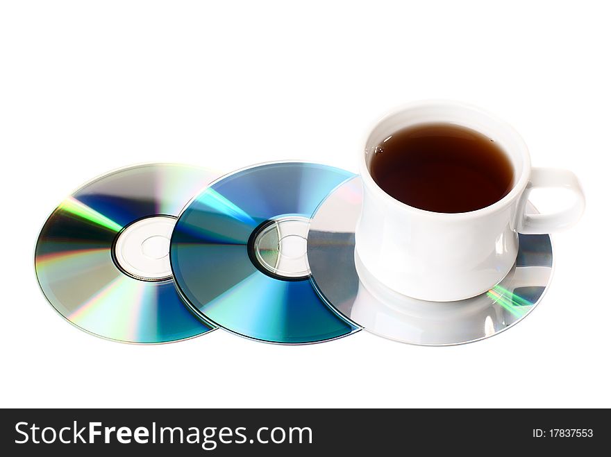 A cup of tea on CD disks. Isolated on white background. A cup of tea on CD disks. Isolated on white background.