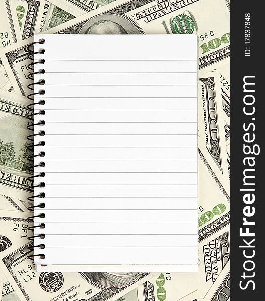 One white notepad on dollars background