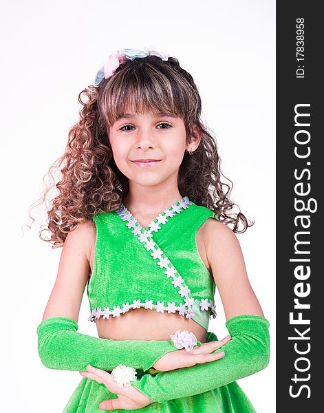 Beautiful little girl dancing in green dress