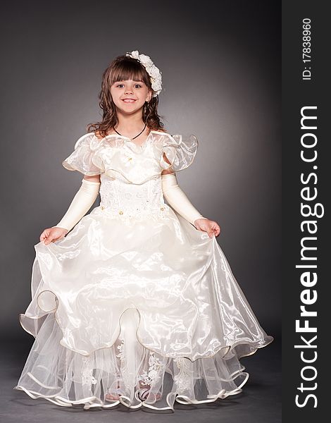 Beautiful little princess dancing in luxury dress