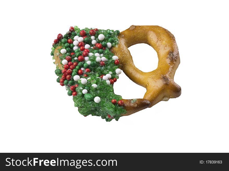 Green candy coated pretzel decorated with sprinkles isolated over white background. Green candy coated pretzel decorated with sprinkles isolated over white background
