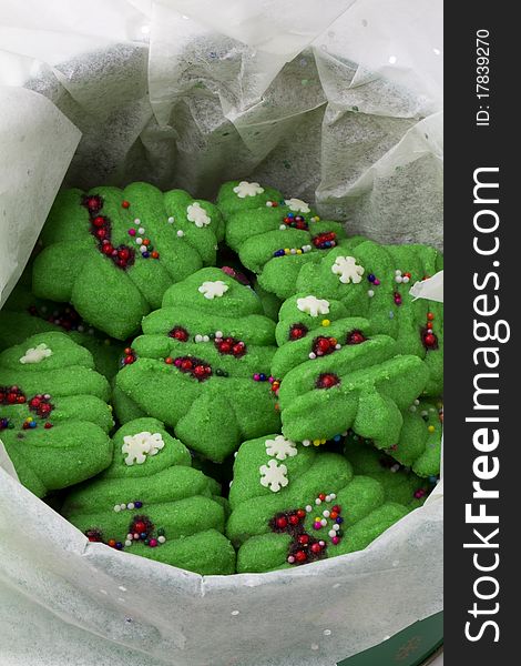 Spritz christmas tree cookies in a tissue lined tin