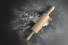 Wooden Dough Roller On The Black Table With Flour Spread Stock Images
