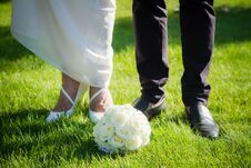 Wedding Bouquet Of The Bride And Feet Newlyweds Stock Images