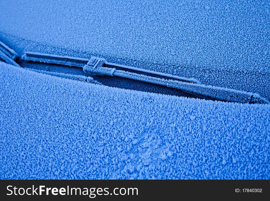 Ice on a blue car during winter season, good for concepts. Ice on a blue car during winter season, good for concepts