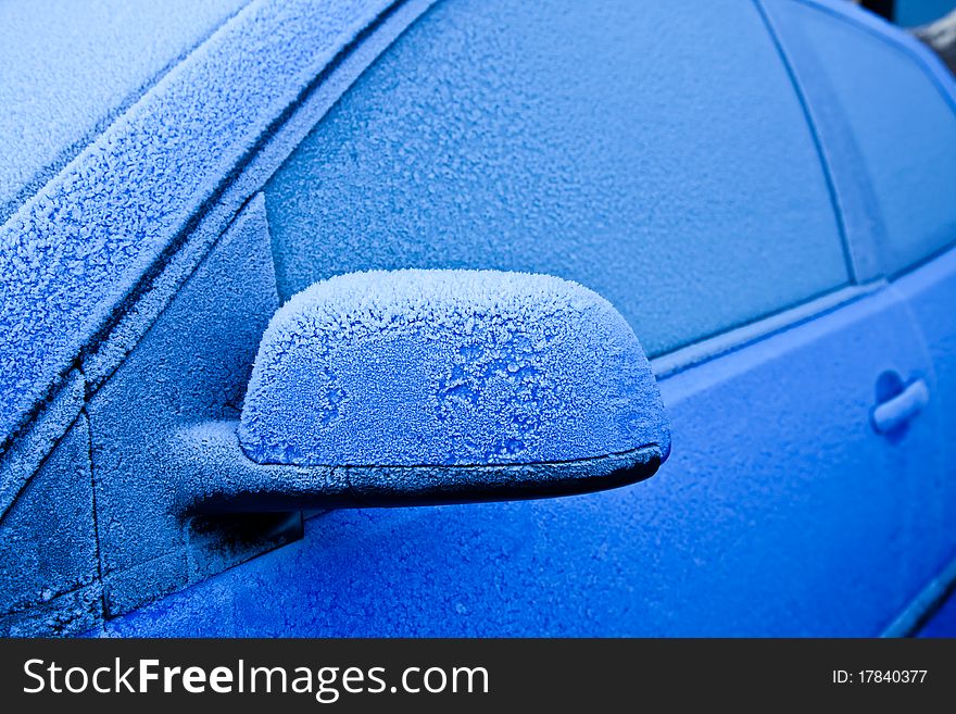 Ice on a blue car during winter season, good for concepts. Ice on a blue car during winter season, good for concepts