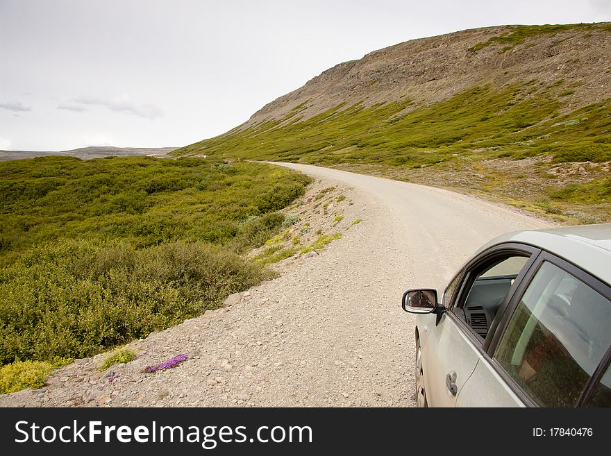 Small gravel route in Iceland. Westfjords. Summer cloudy day. Small gravel route in Iceland. Westfjords. Summer cloudy day.