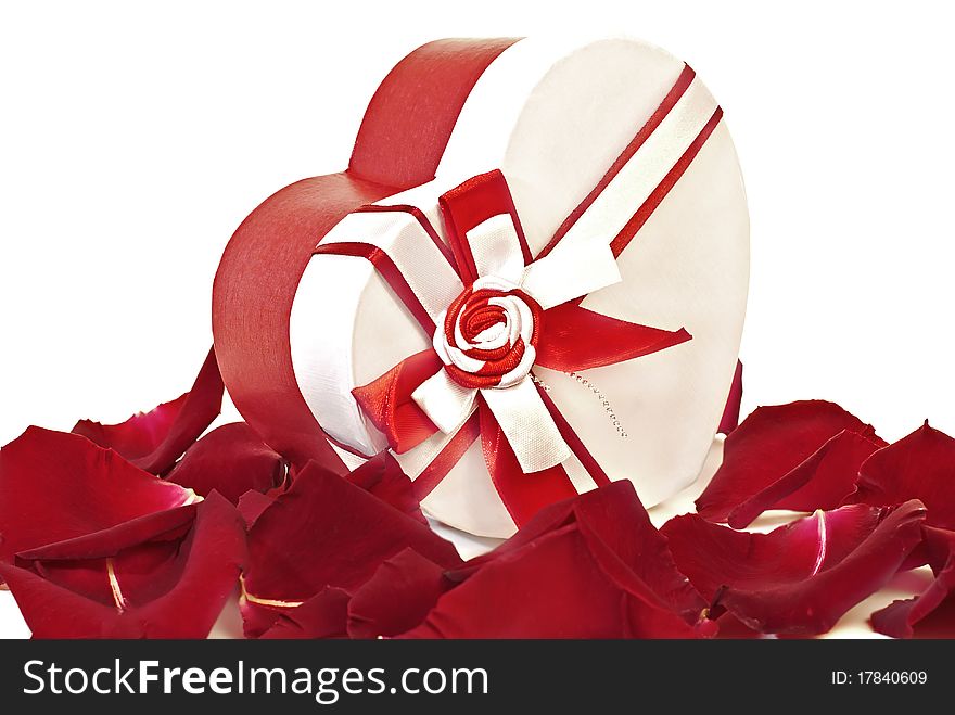 Gift box in shape heart with petals of roses on a white background