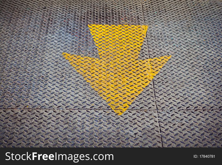 Yellow arrow Paint on steel floor plate