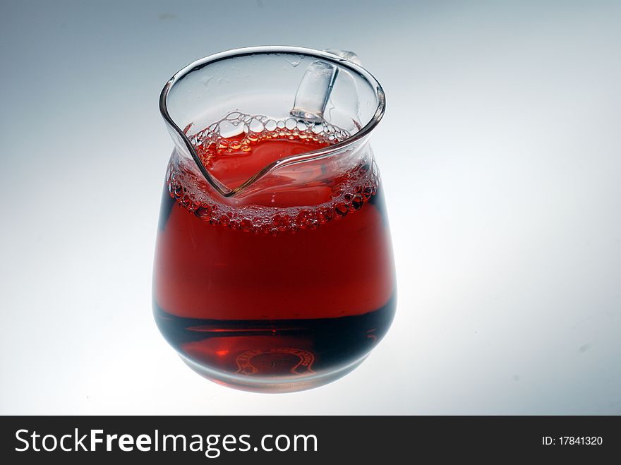 A glass is full of tea with white background. A glass is full of tea with white background.