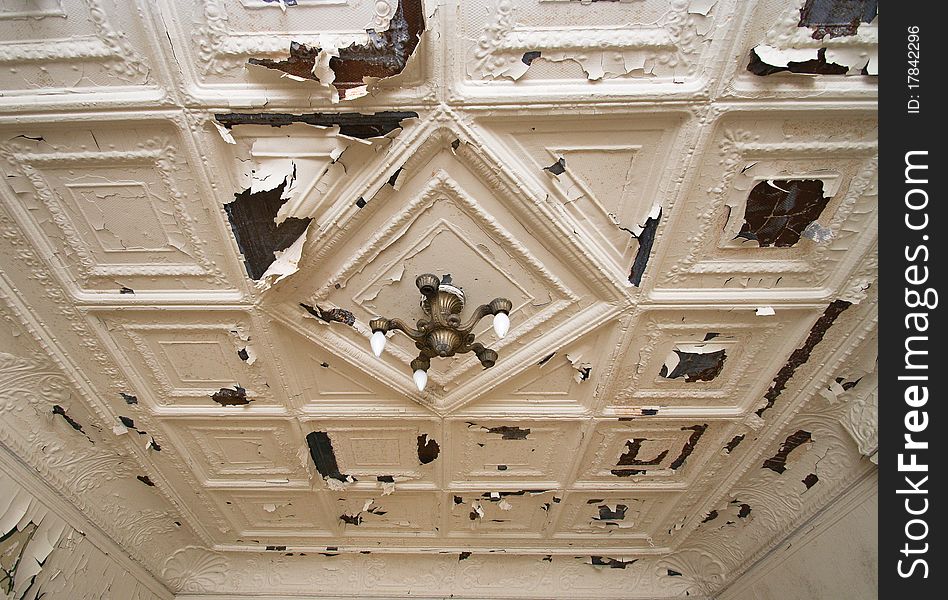 Image from an abandoned home, of an old victorian ceiling with lots of peeling paint.