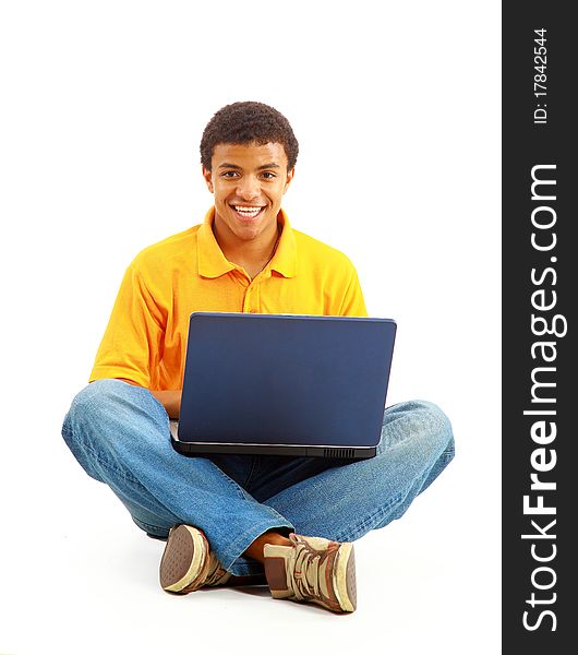 Happy young man working on a laptop, isolated against white background