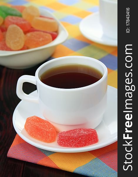Cup of tea and fruit candy.