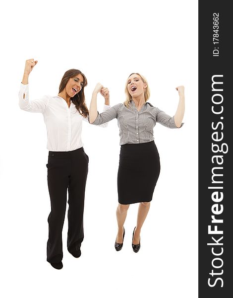 Two business women with arms aloft as though celebrating. Two business women with arms aloft as though celebrating