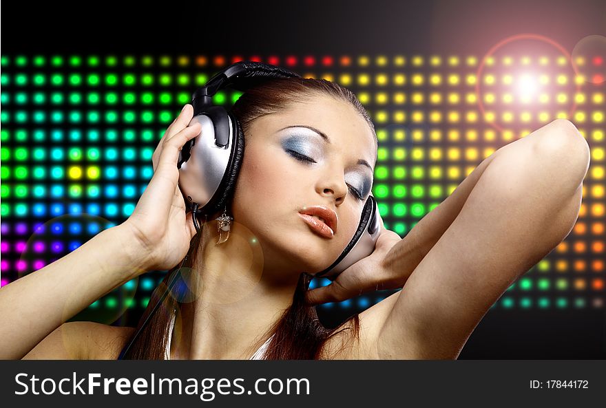 Portrait of a young dancing girl in headphones