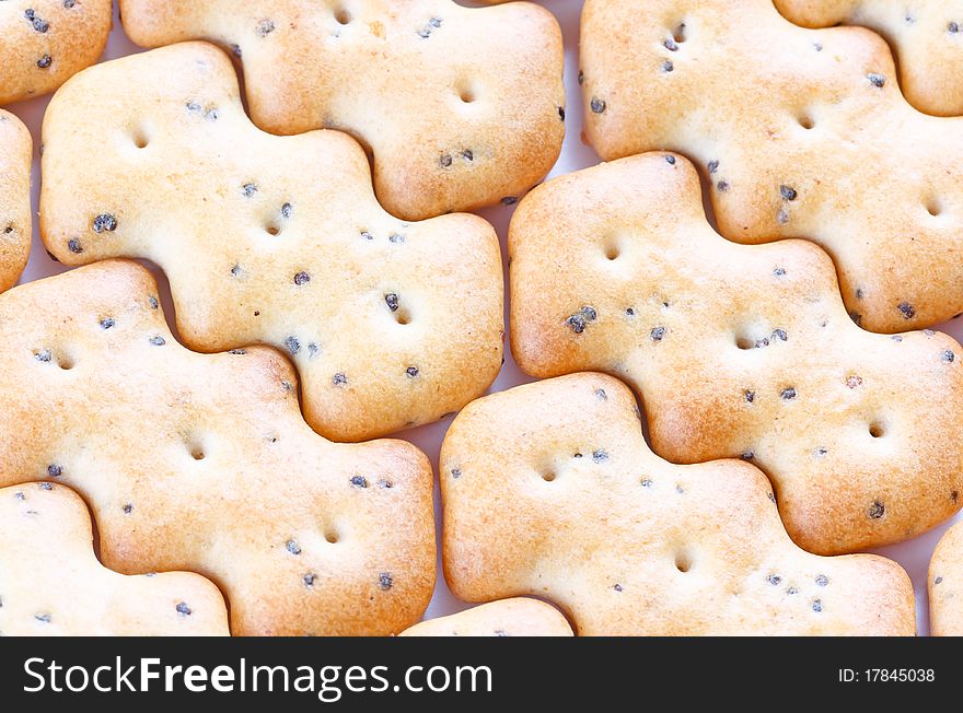 Small shaped browned crisp biscuits as tile background