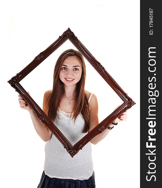 An beautiful teenager standing with an picture frame and gray t-shirt, with
her long brunette hair, over white background. An beautiful teenager standing with an picture frame and gray t-shirt, with
her long brunette hair, over white background.