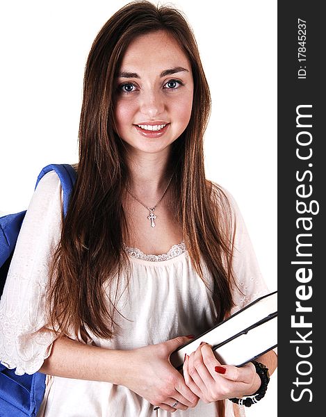 A pretty teenager in a beige blouse and a blue backpack over her shoulder
and books in her hand, standing in the studio for white background. A pretty teenager in a beige blouse and a blue backpack over her shoulder
and books in her hand, standing in the studio for white background.
