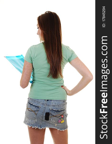 A pretty teenager in a green T-shirt and a blue short skirt, with long 
brunette hair, standing from the back in the studio for white background. A pretty teenager in a green T-shirt and a blue short skirt, with long 
brunette hair, standing from the back in the studio for white background.