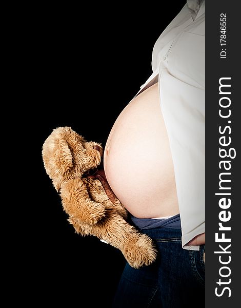 Pregnant belly and teddy bear. Pregnant belly and teddy bear