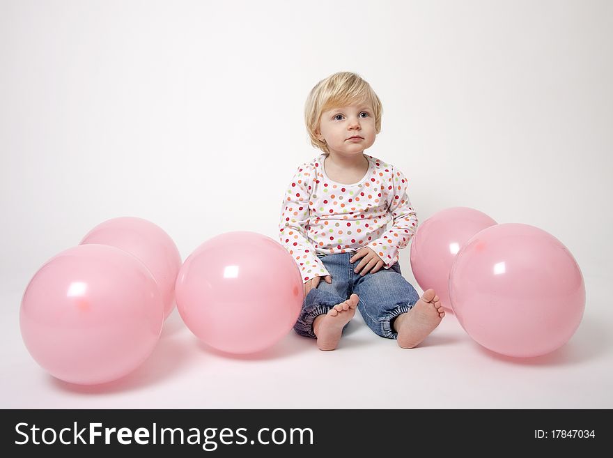 Cute girl with pink balloons at the party