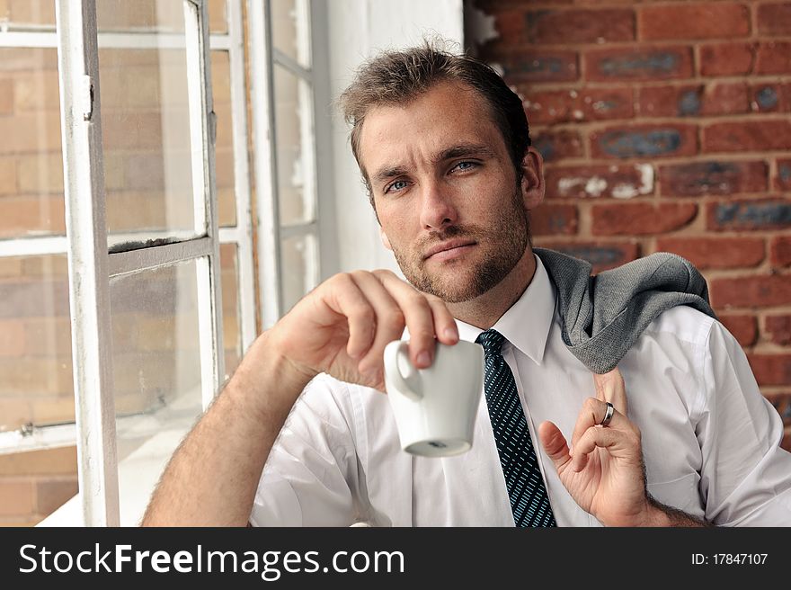 Confident portrait of an attractive man next to window. Confident portrait of an attractive man next to window