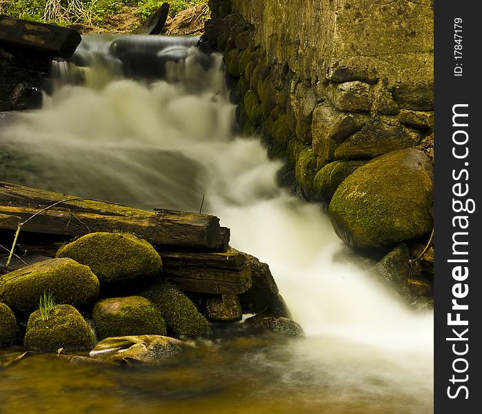 Impetuous stream framed by mossy stones. Impetuous stream framed by mossy stones